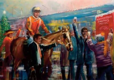 Jockey in orange silks celebrates on a horse, surrounded by cheering crowd and a Christmas tree at Leopardstown Festival
